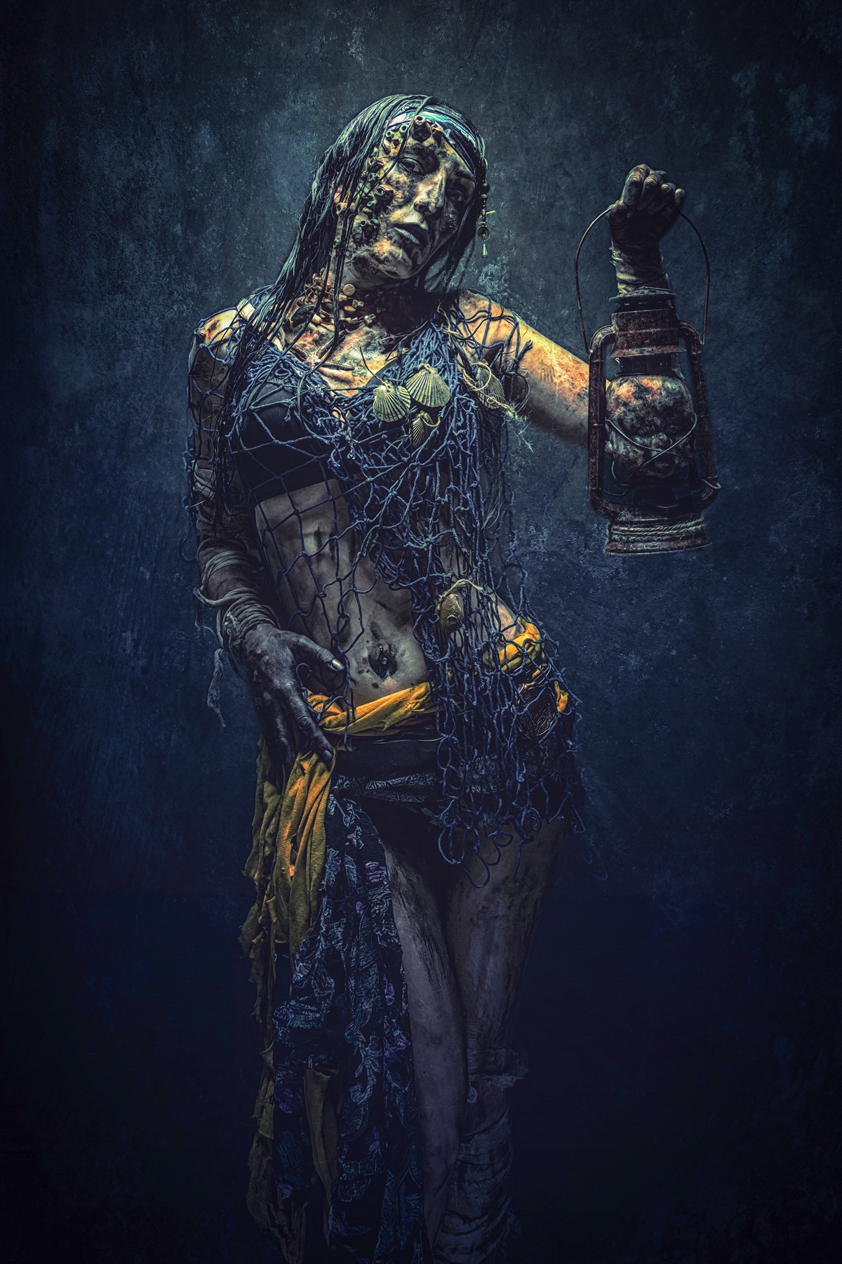 A haunting fine art portrait of a sea siren with weathered skin, entangled in dark blue fishing nets and seashells, holding an antique lantern against a dark, textured background.